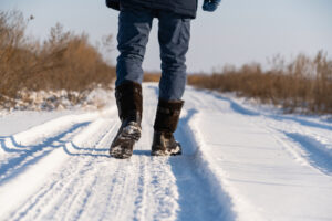 Man walking on a snowy road.