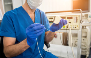 Doctor holding tools for radiofrequency ablation. 